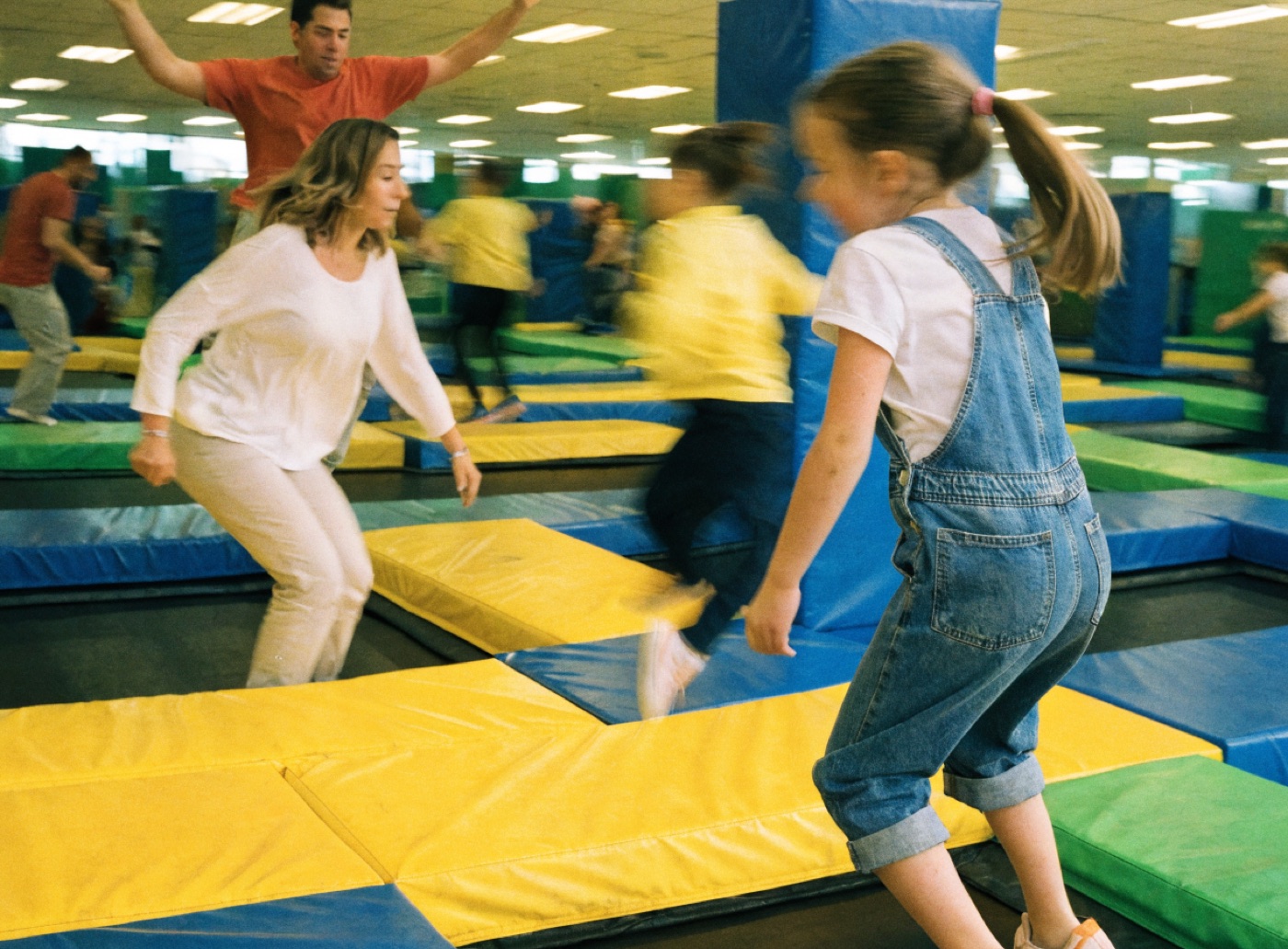 Families jumping in an indoor trampoline park
